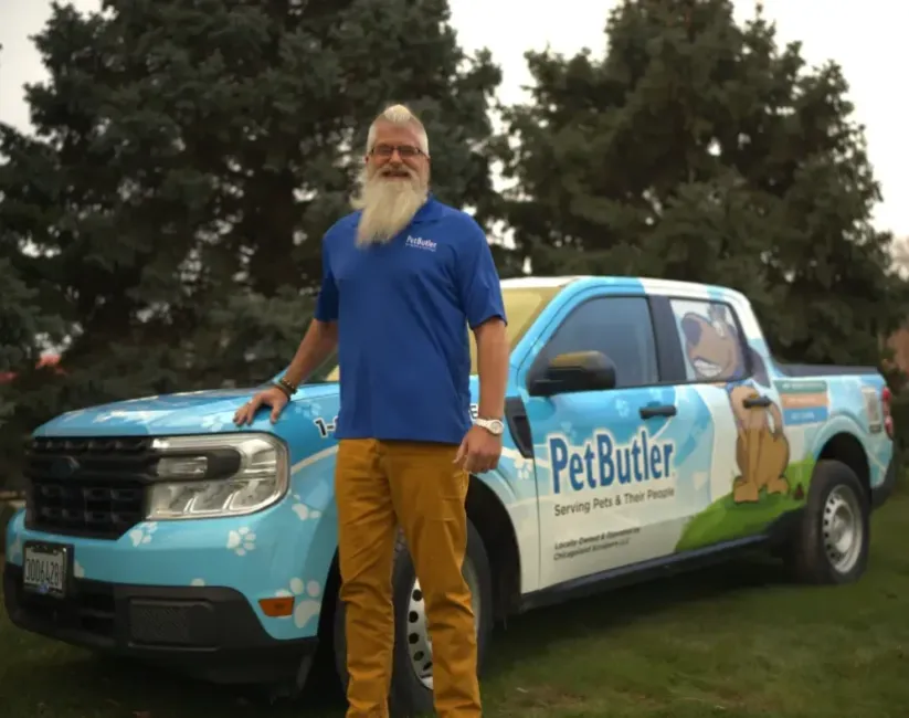 Bryan Pierce, Operations Manager of Pet Butler of Columbus, OH, standing next to a Pet Butler truck.