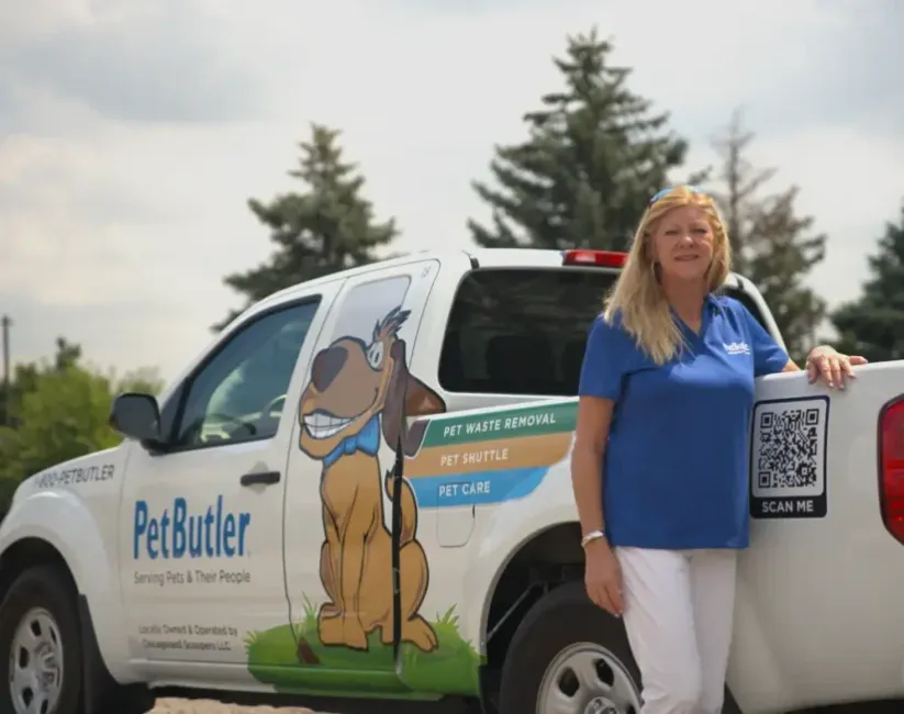 Susan Curtis, owner of Pet Butler of Franklin, TN, standing next to a Pet Butler truck.