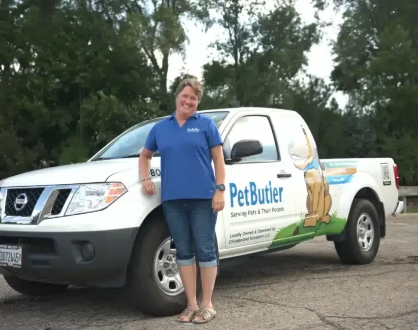 Aimee Braatz, owner of Pet Butler of Waukesha, WI, standing next to a Pet Butler truck.
