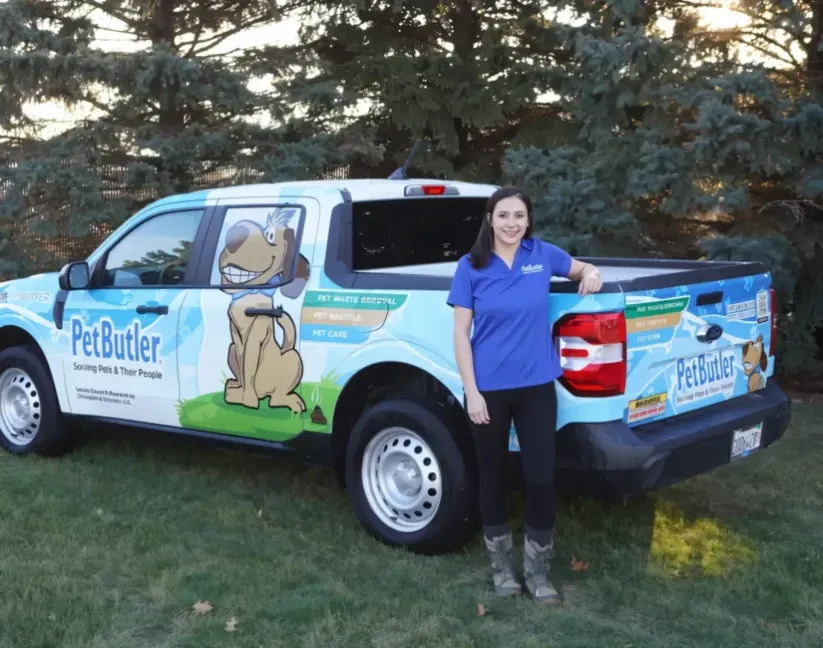 Jordan Dalton, owner of Pet Butler of North Denver, CO, standing next to a Pet Butler truck.