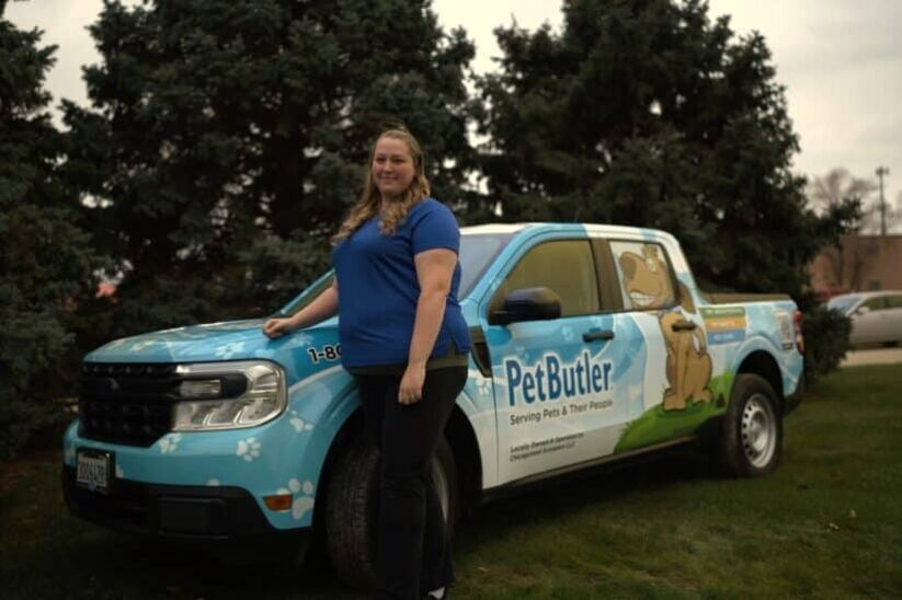 Jennifer Folsom, owner of Pet Butler of Londonderry, NH, standing next to a Pet Butler truck.