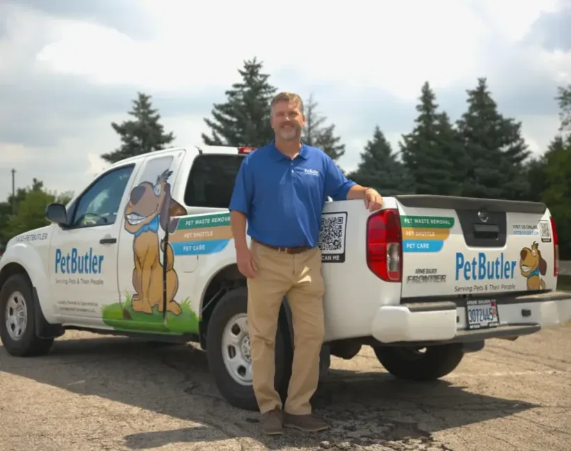 Pat Lanigan, owner of Pet Butler of Des Moines, IA, standing next to a Pet Butler truck.