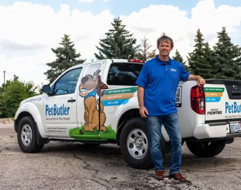 Ryan Leland, owner of Pet Butler of Bellevue, WA, standing next to a Pet Butler truck.