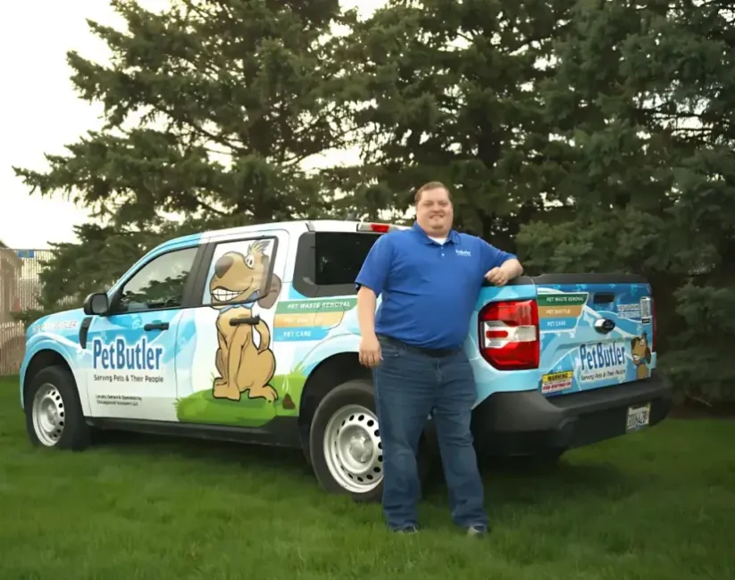 Rob Moore, owner of Pet Butler of Clarksville, TN, standing next to a Pet Butler truck.