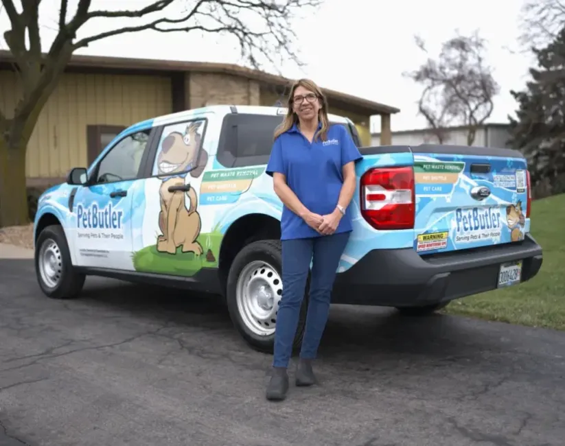 Tami Porteous, owner of Pet Butler of Grand Rapids, MI, standing next to a Pet Butler truck.
