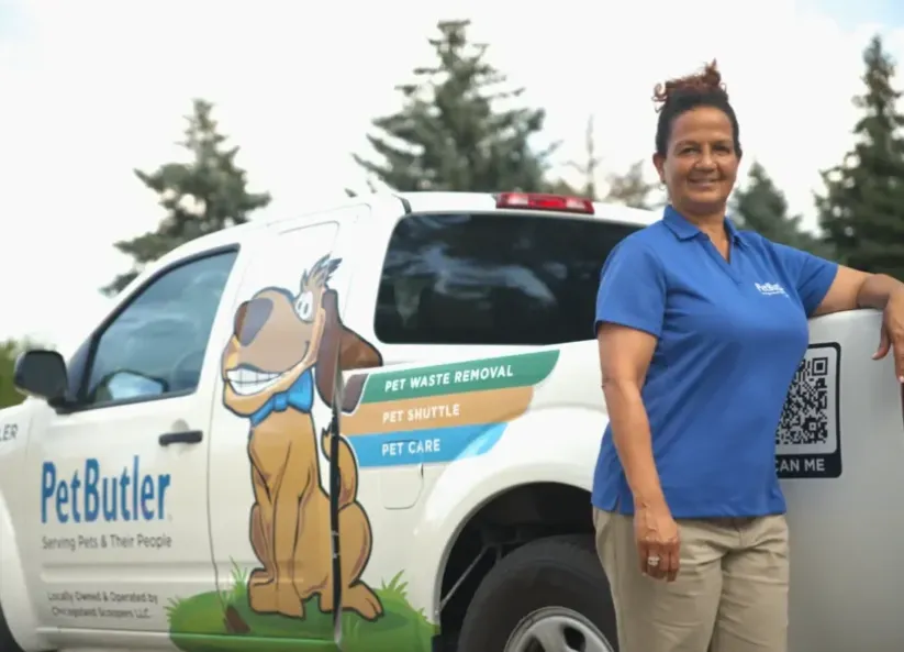 Rebecca Stewart, owner of Pet Butler of Lithonia, GA, standing next to a Pet Butler truck.
