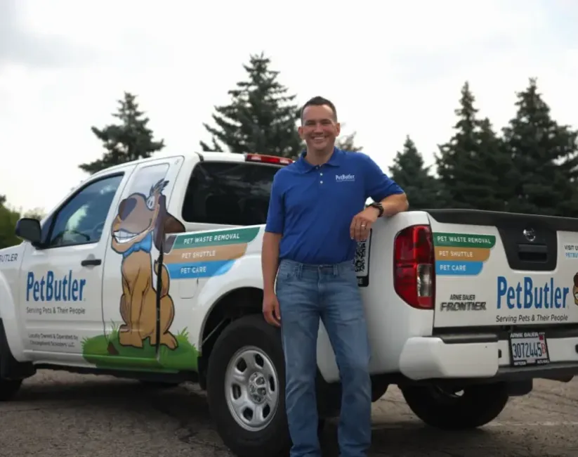 Andy Wiltz, owner of Pet Butler of Kansas City, KS, standing next to a Pet Butler truck.