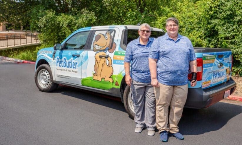 Georgeann Caperna, owner of Pet Butler New City, stands next to her Pet Butler truck.