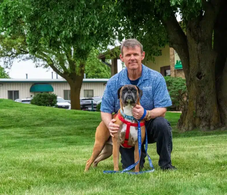 Ryan Leland, owner of Pet Butler Bellevue WA, posing with a dog while out on a walk