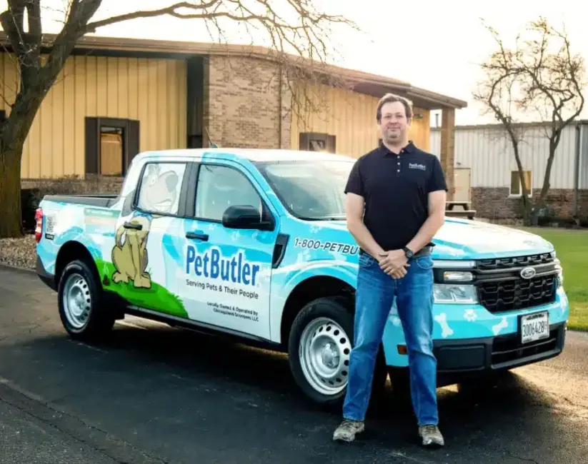 Caleb Davis, owner of Pet Butler of Lexington, KY standing next to a Pet Butler truck.
