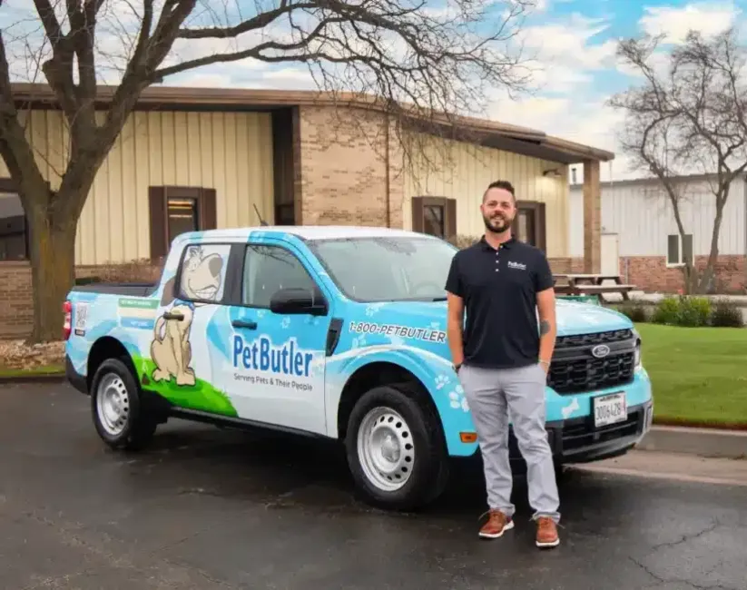 Leo Hetzendorfer, owner of Pet Butler of St. Petersburg, FL standing next to a Pet Butler truck.