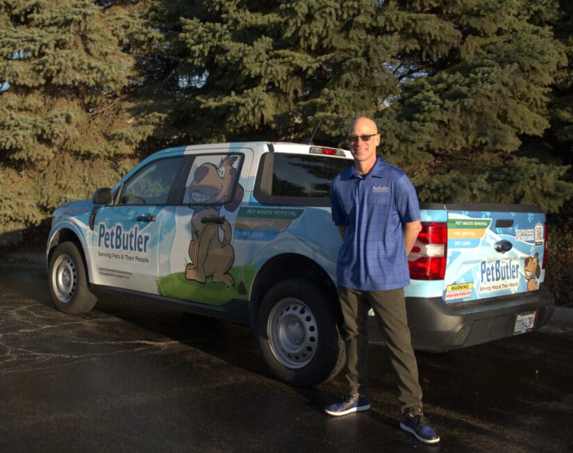Pet Butler Franchise owner in front of Pet Butler truck
