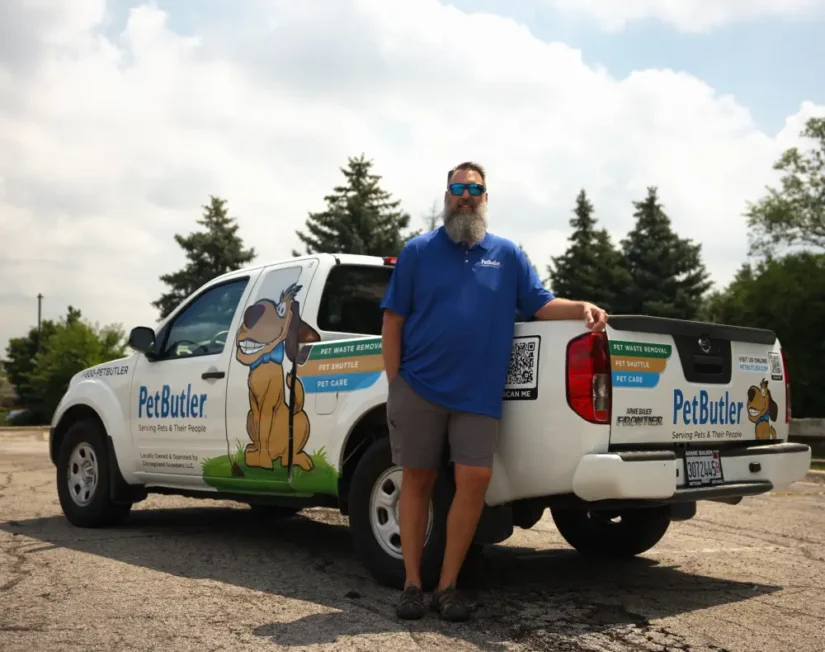 Scott Cockrell, owner of Pet Butler of Huntsville, AL, standing next to a Pet Butler truck.