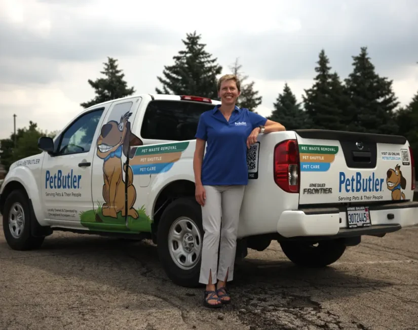 Kelly Amundson, owner of Pet Butler of Rochester, MN, standing next to a Pet Butler truck.