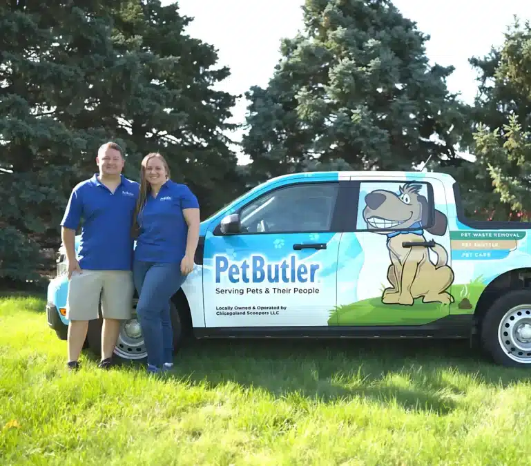 Nick and Rachel Graziano, owners of Pet Butler of Ann Arbor, MI, standing next to a Pet Butler truck.