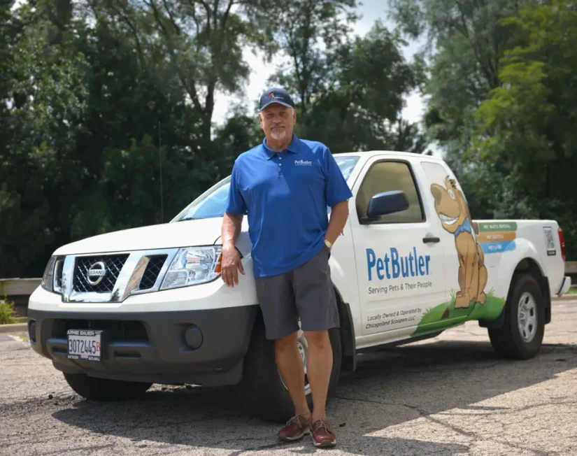 Don Stone, owner of Pet Butler of Dallas, TX, standing next to a Pet Butler truck.