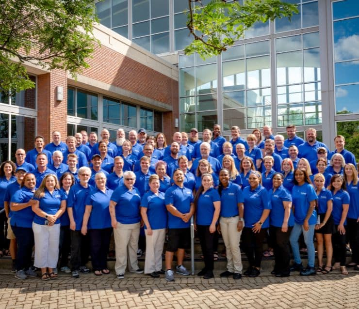 A group of Pet Butler professionals wearing blue logoed polo shirts.