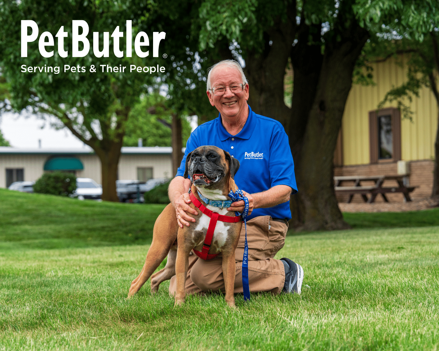 Pet Butler pet care professional smiling while posing with a dog.