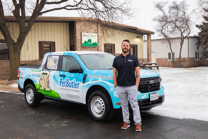 Leo Hetzendorfer, owner of Pet Butler of St. Petersburg, FL standing next to a Pet Butler truck.