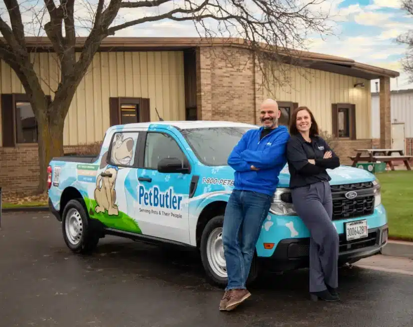 Ziv Tarsi and Kat Stupka, owners of Pet Butler of Portland, OR standing next to a Pet Butler truck.